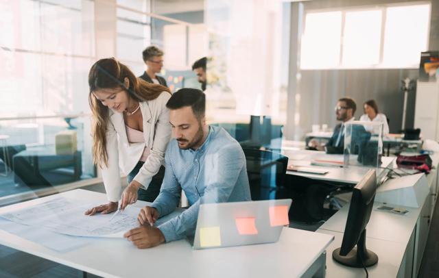 Group of coworkers working together on business project in office